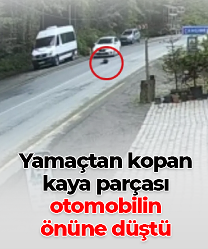 Yamaçtan kopan kaya parçası otomobilin  önüne düştü